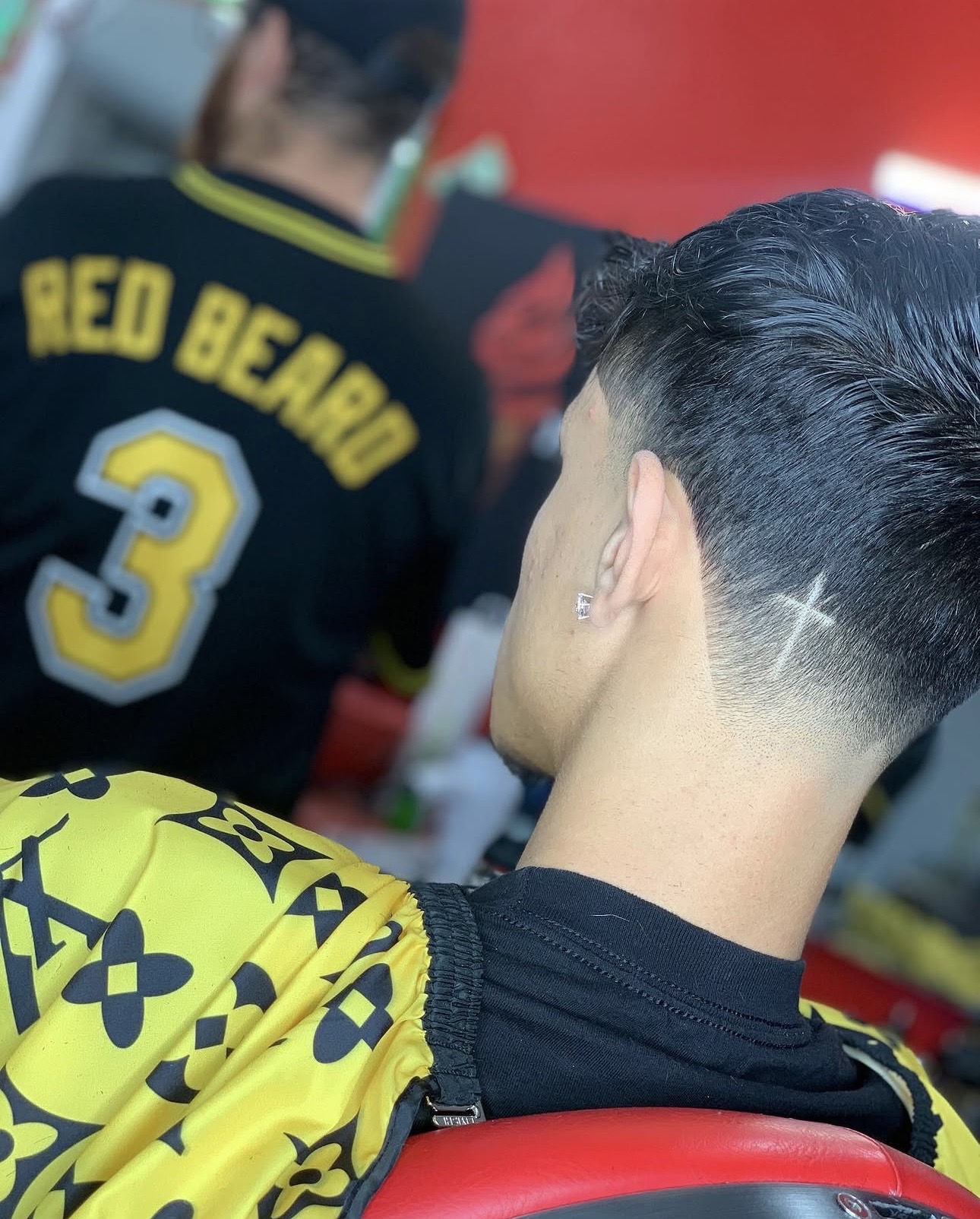 Textured comb-over with a skin fade and cross detail